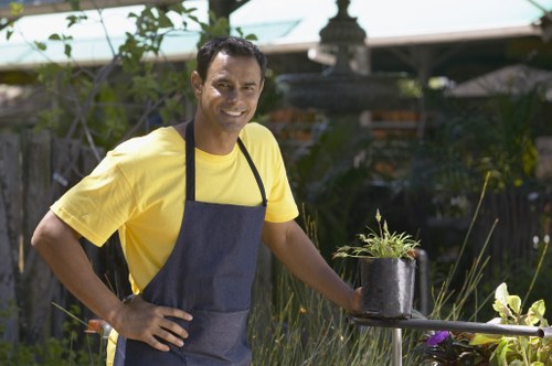 Gardener enhancing hedge health with professional trimming tools
