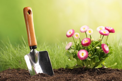 Professional lawn care team maintaining a garden in Earls Court